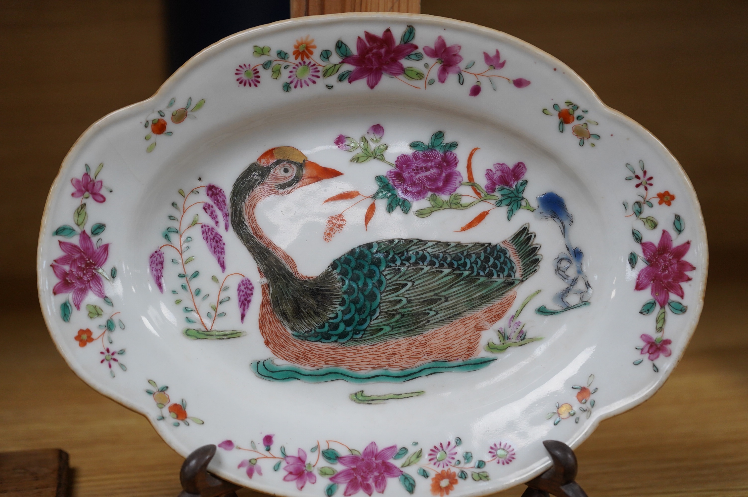 A Chinese export famille rose ‘goose’ dish, Qianlong period, on hardwood stand, 21cm. Condition - fair, one hairline crack